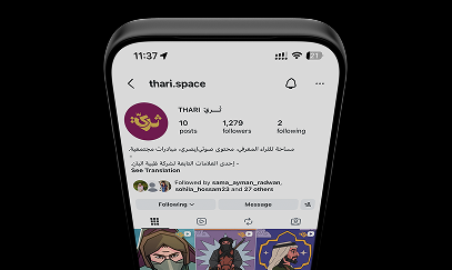 A phone showing a social media profile with a grid of illustrated posts